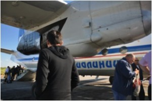 Self-unloading cargo and luggage from the Antonov AN-26-100 at Yakutsk airport. Luggage is strictly limited to 20kg per person and every spare gram is filled with frozen fish (Chir), being the heaviest part of the luggage (Photo: L. Schaepman, July 2013).