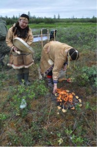 Two Eveni women in their role as shaman during the opening ceremony of Kodak station. While one is singing and playing the drum, the other is sacrificing food to the gods of nature. Photo: G. Schaepman-Strub, 16 July 2013.