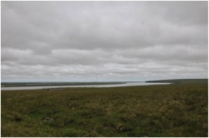 Ayutun hill site (max elevation about 300 m a.s.l.) with overview of the Indigirka river (as well as cold and bad weather moving out …) (Photo: M. Schaepman, July 2013).